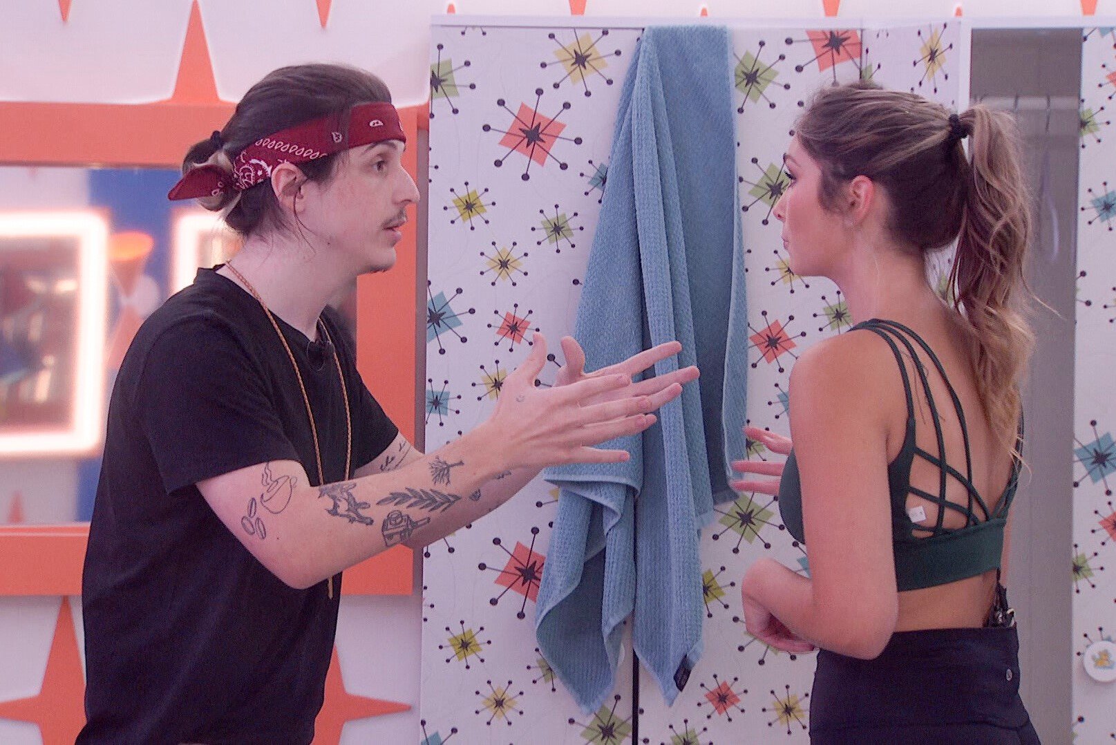 Matthew Turner and Alyssa Snider, who, according to 'Big Brother 24' spoilers, is going to be evicted on Thursday, Sept. 15, talk during the double eviction. Turner wears a black shirt, red bandana, and the HOH key around his neck. Alyssa wears a dark green sports bra and black leggings.