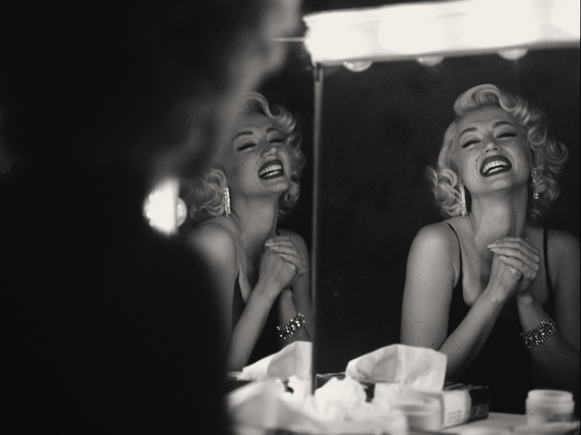 'Blonde' Ana de Armas as Marilyn Monroe in black-and-white picture smiling at herself in the mirror