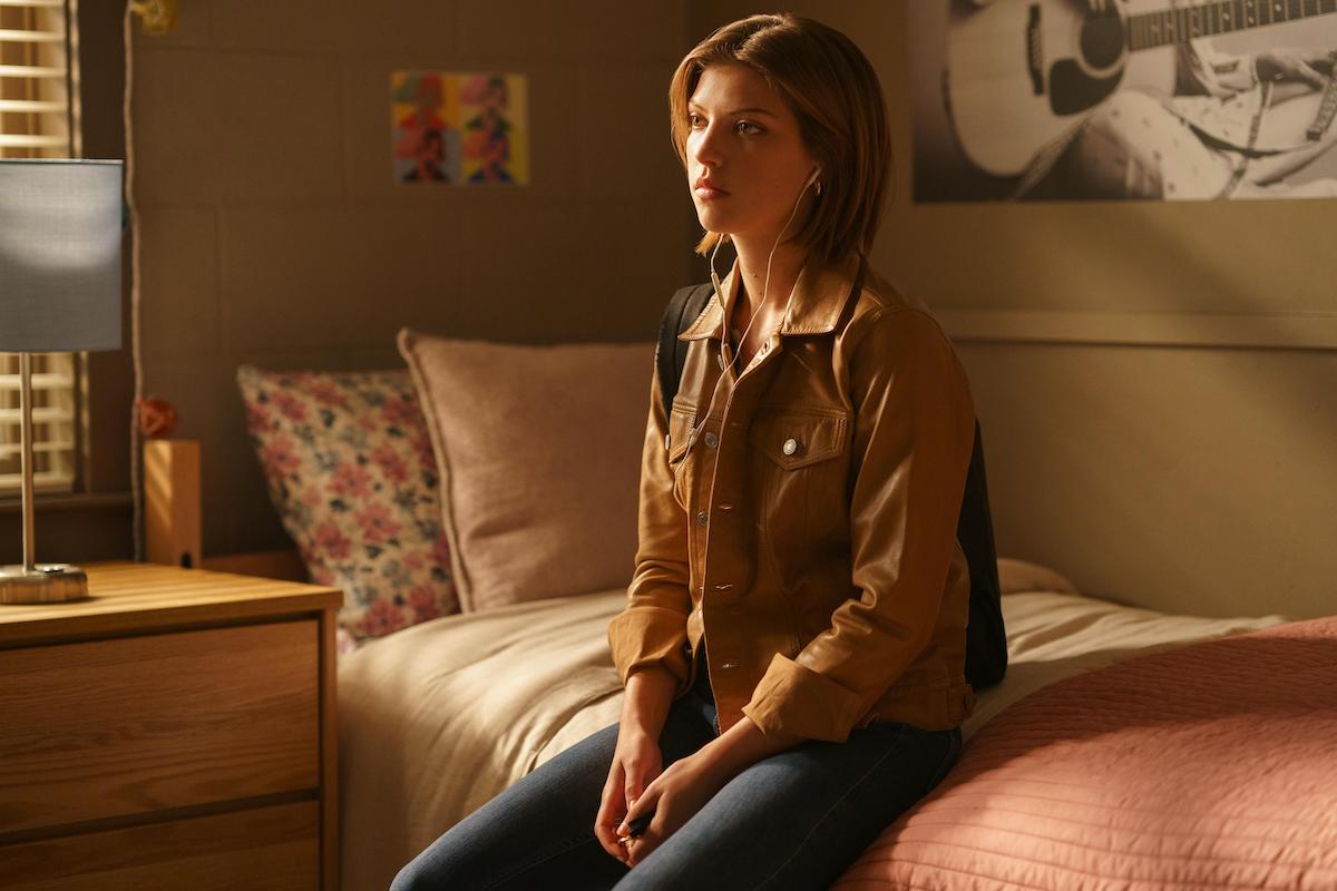 Catherine Missal sits on a bed in episode 4 of season 1 of 