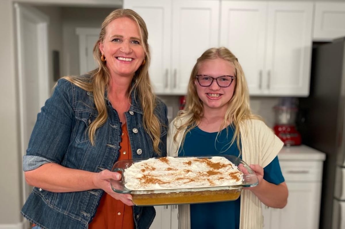 Christine Brown and Truely Brown hold up a cake they made on 'Cooking with Just Christine' on TLC.