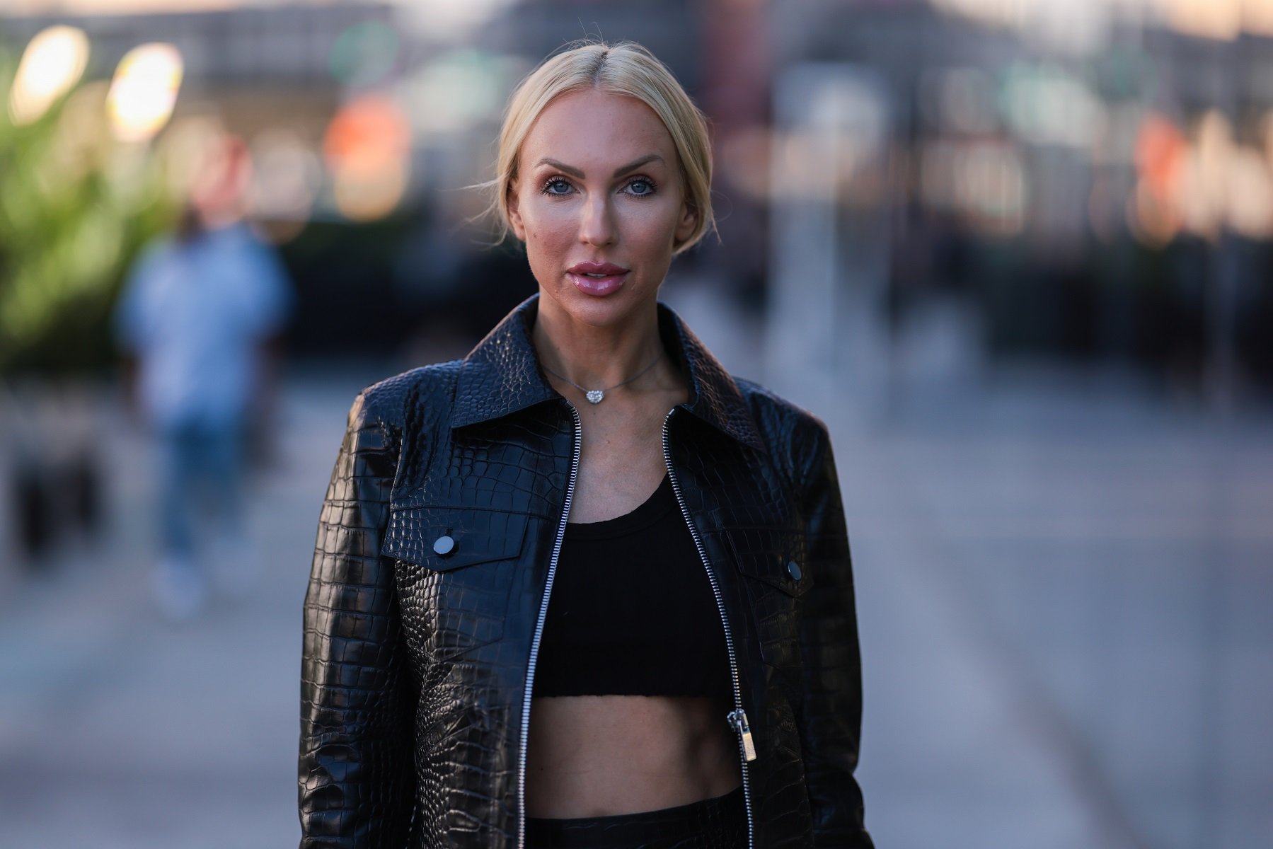 Christine Quinn seen wearing a black cropped top, black leather skirt, leather jacket, black sunglasses and black heels outside Michael Kors during New Yorker Fashion Week. Quinn is best known for her work on 'Selling Sunset'