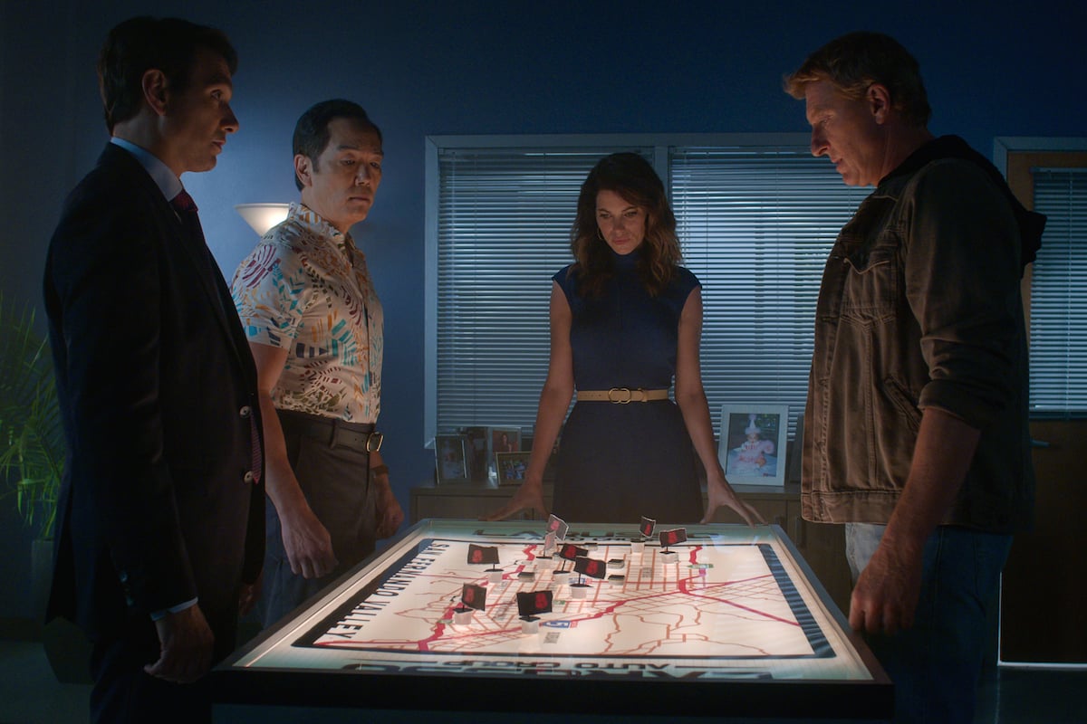 'Cobra Kai' Season 5: Johnny Lawrence (William Zabka) stands around a map with Amanda (Courtney Henggeler), Chozen (Yuji Okumoto), and Daniel (Ralph Macchio)