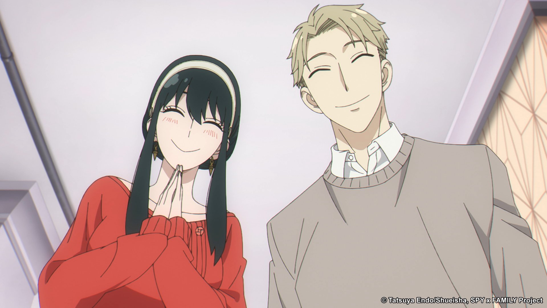 Yor and Loid Forger in 'Spy x Family' for our list of cozy anime to watch during fall 2022. Both are wearing sweaters and smiling at someone.