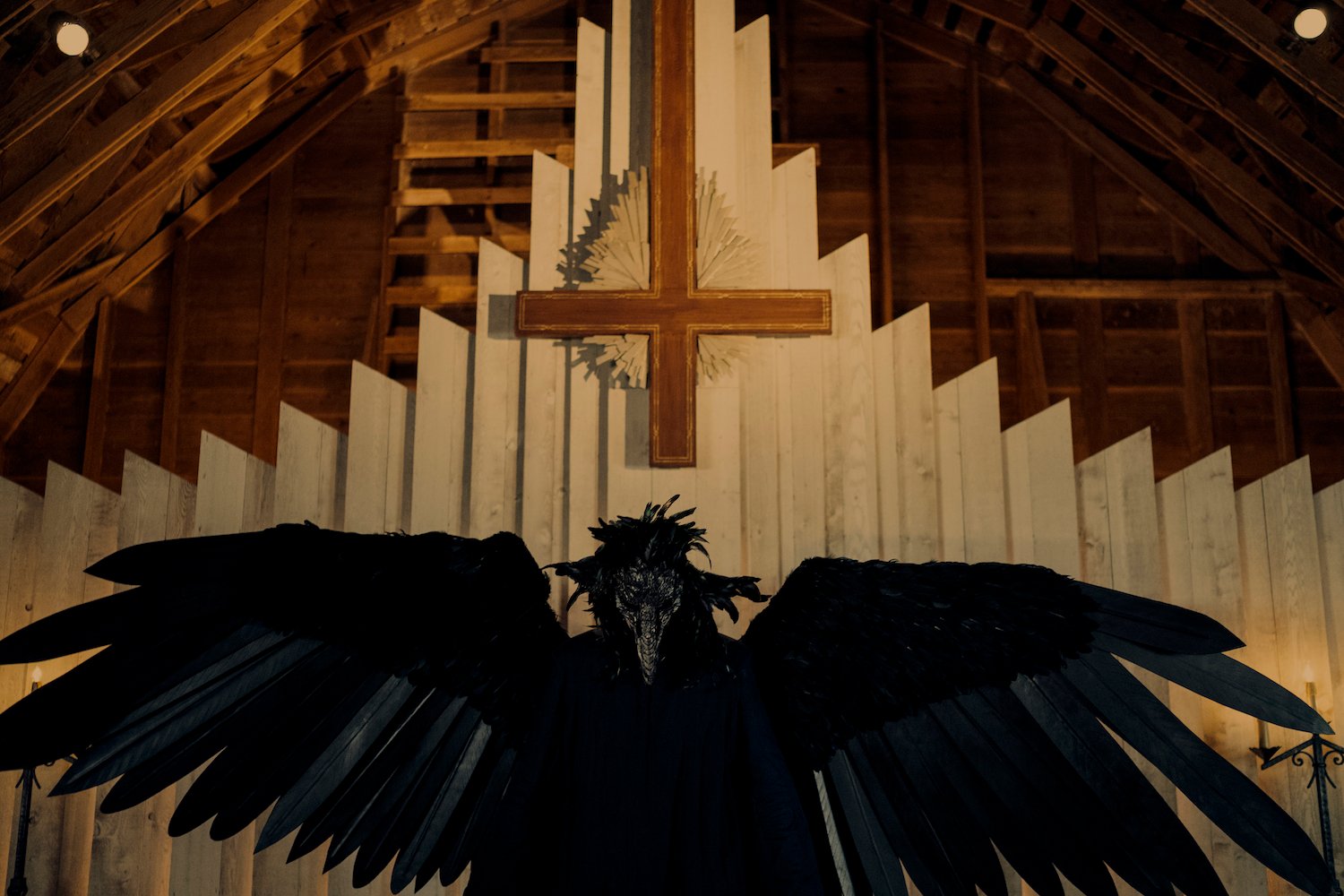 A production still featuring a large black bird and an upside down cross from Netflix's 'Devil in Ohio' which is partially based on true events.