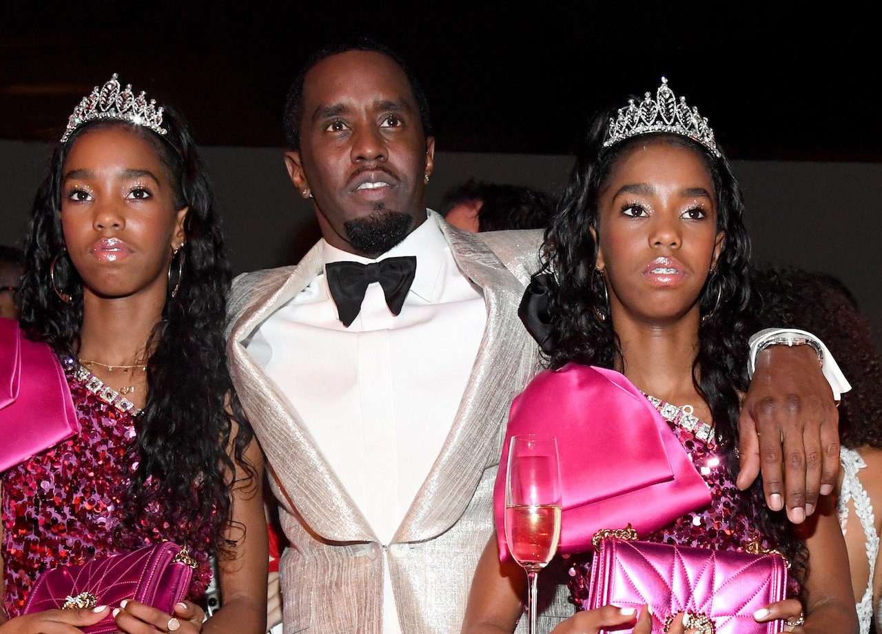 Diddy with his twin daughters at his 50th birthday party; his former nanny is suing him