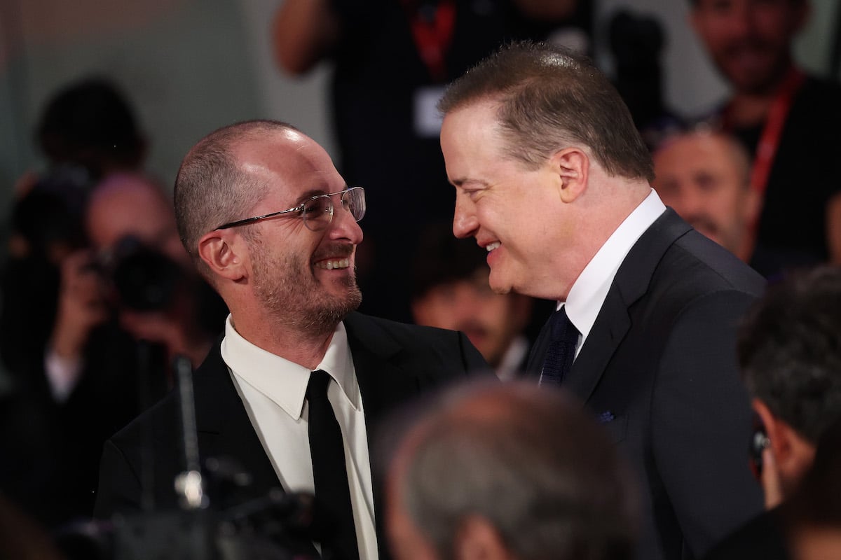 Director Darren Aronofsky and Brendan Fraser smile at each other at "The Whale" premiere at the 79th Venice International Film Festival