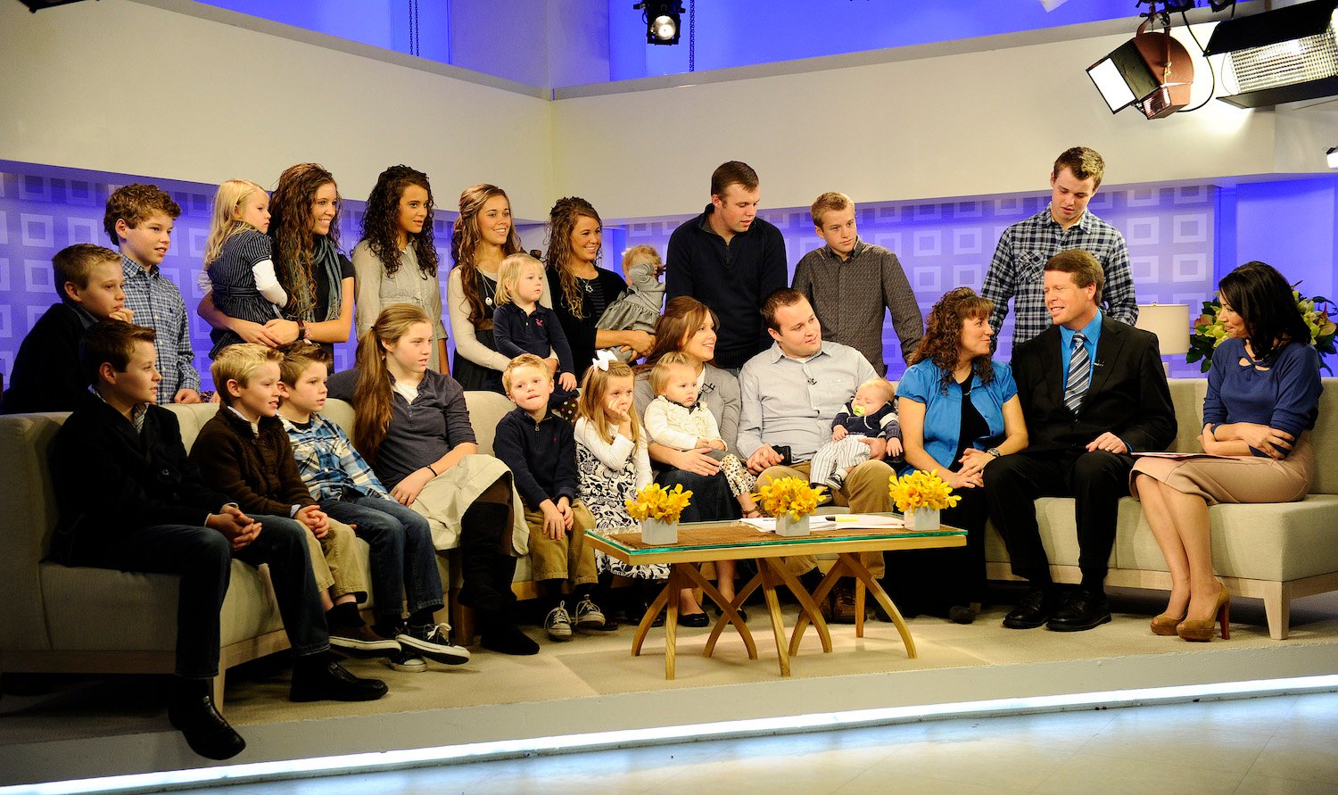 The Duggar family discussing Duggar news with a news station