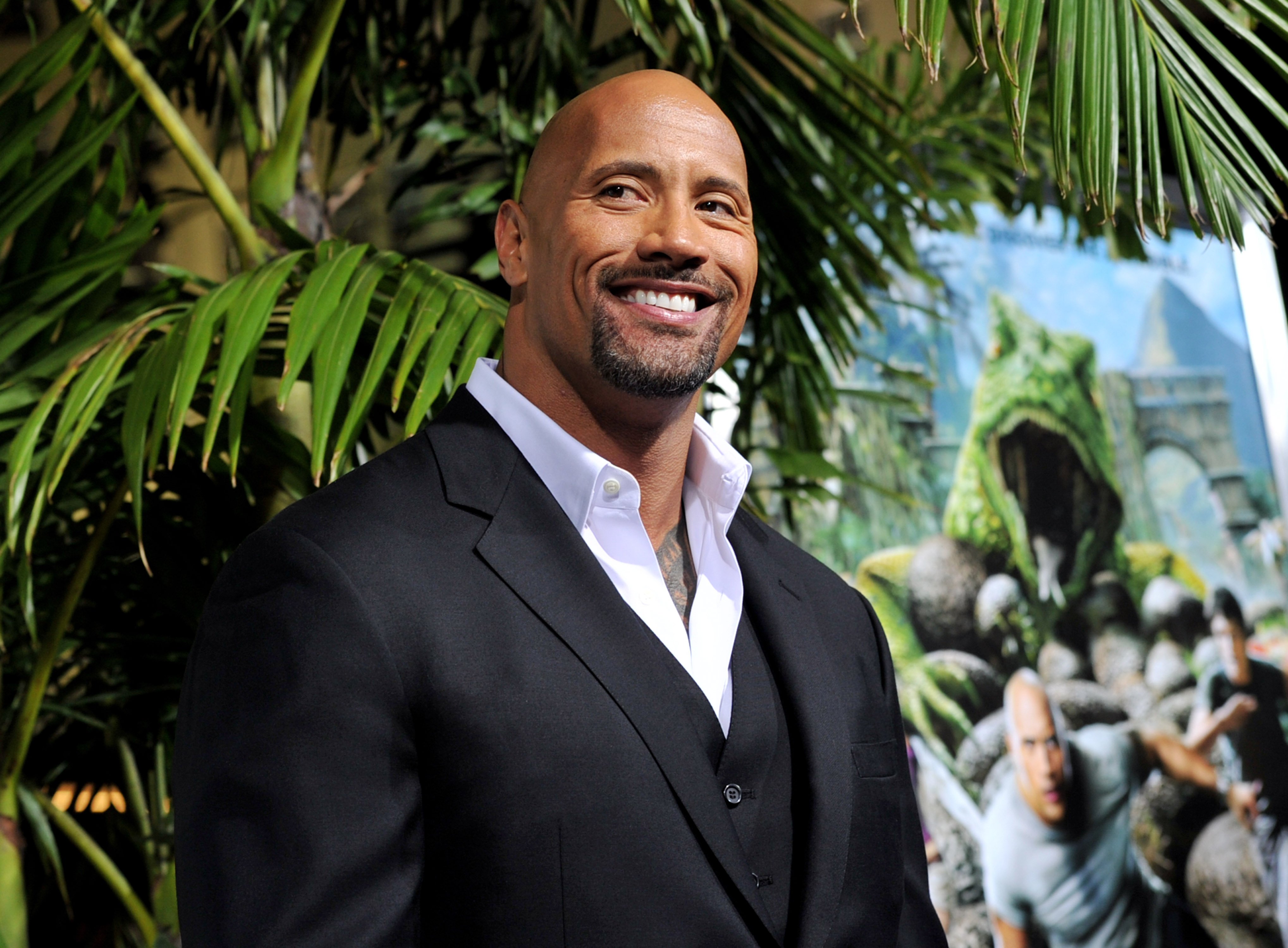 Dwayne Johnson poses at a media event.