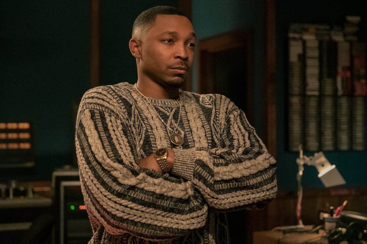 Malcolm Mays as Lou Lou wearing a coogi sweater and gold watch in 'Power Book III: Raising Kanan '