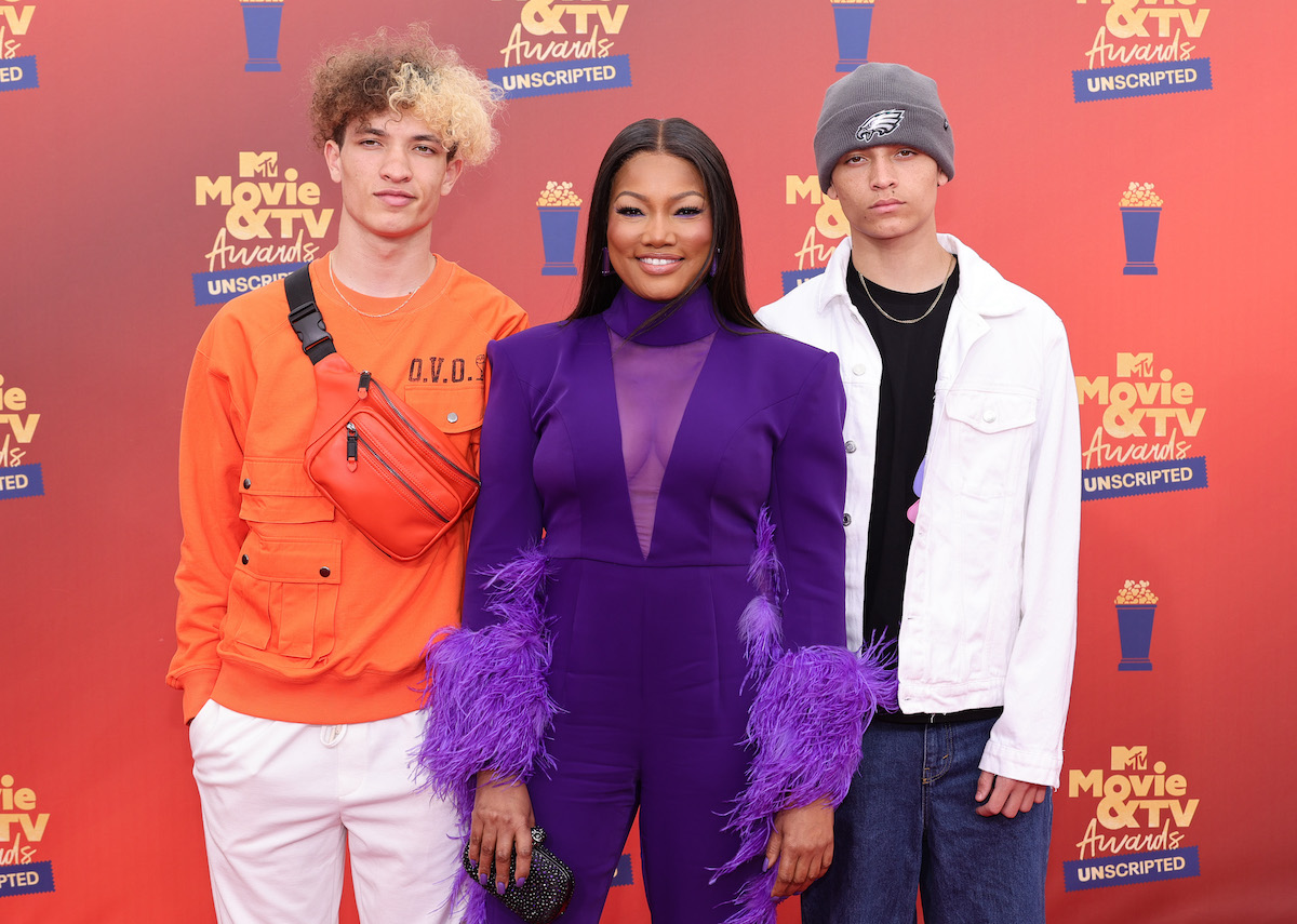 Garcelle Beauvais smiles with her sons, Jaid Thomas Nilon and Jax Joseph Nilon at the 2022 MTV Movie & TV Awards