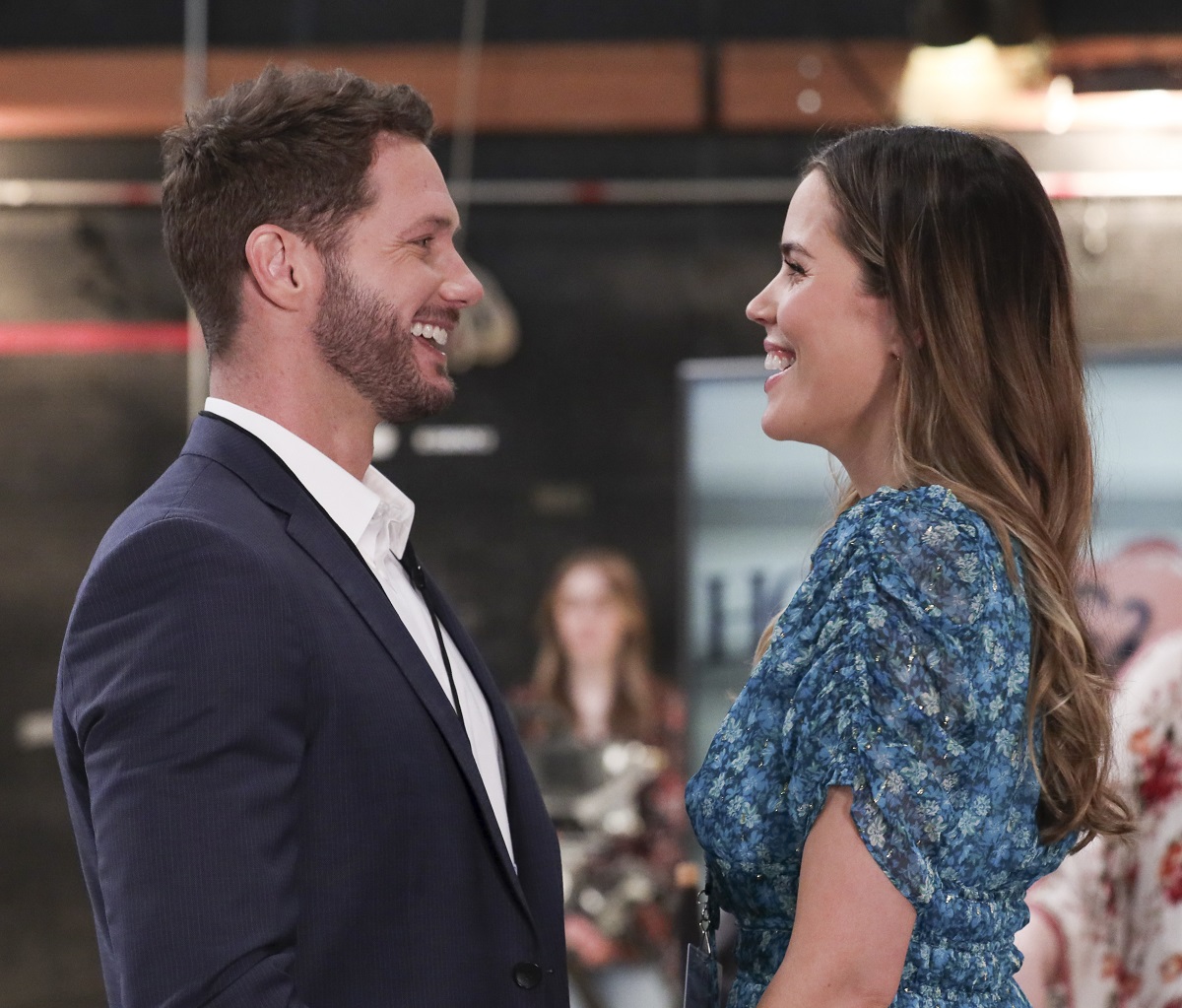 'General Hospital' star Johnny Wactor in a blue suit, and Sofia Mattsson in a blue floral dress in a scene from the soap opera.