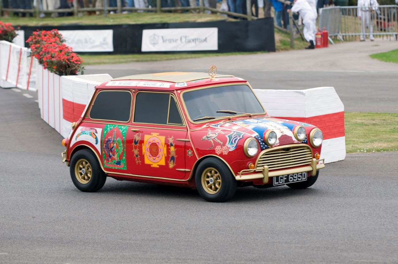 George Harrison's customized Mini Cooper is parked on the asphalt. 