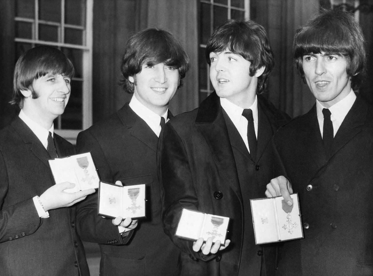 The Beatles holding their MBEs in 1965.
