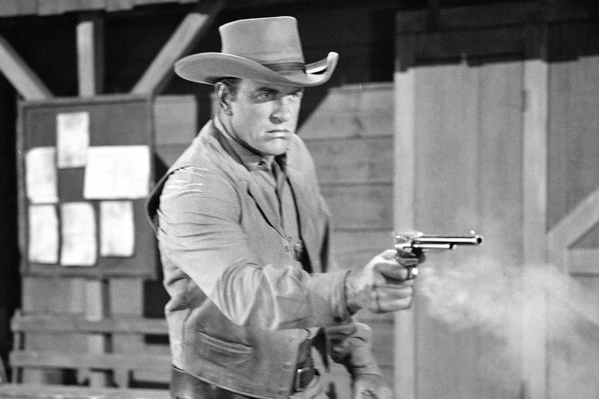 'Gunsmoke' James Arness as Matt Dillon until CBS decided to cancel it. He's wearing a Western costume and holding his gun out with smoke coming from firing it.