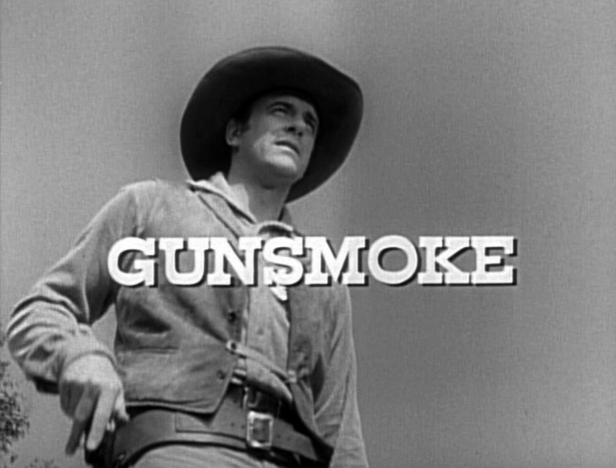 'Gunsmoke' episodes James Arness as Marshal Matt Dillon. He's wearing a Western costume with his hand on his gun in the holster with the show title over the image.
