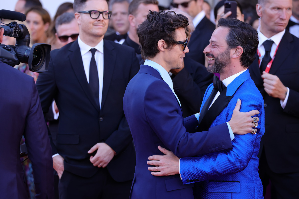 Harry Styles and Nick Kroll hug each other at the "Don't Worry Darling" red carpet at the 79th Venice International Film Festival