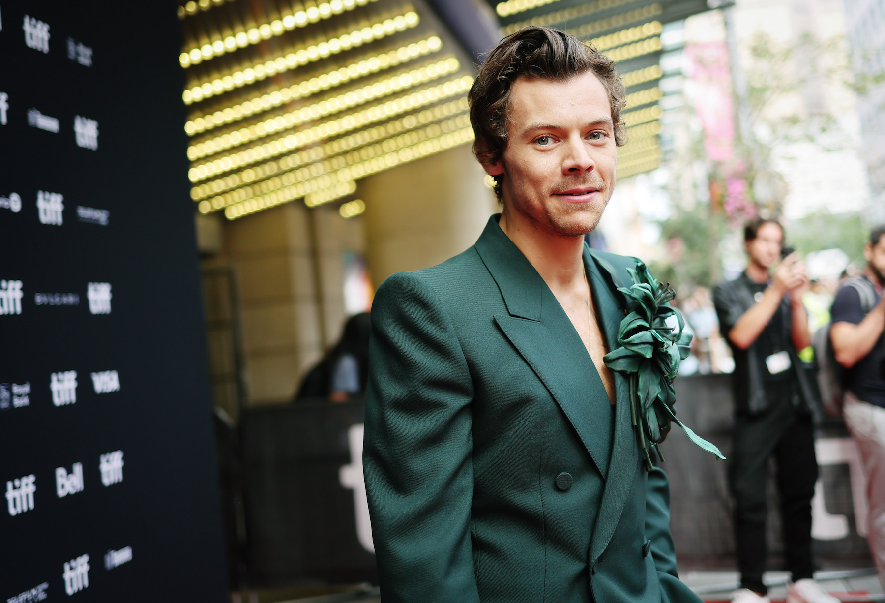 Harry Styles, who shares a record with Prince, Beyoncé, and Eminem, wearing a green suit.