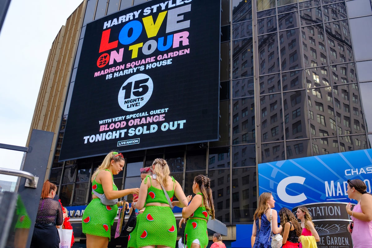 Fans wearing themed outfits take photos outside Madison Square Garden before the Harry Styles Love On Tour 2022 concert