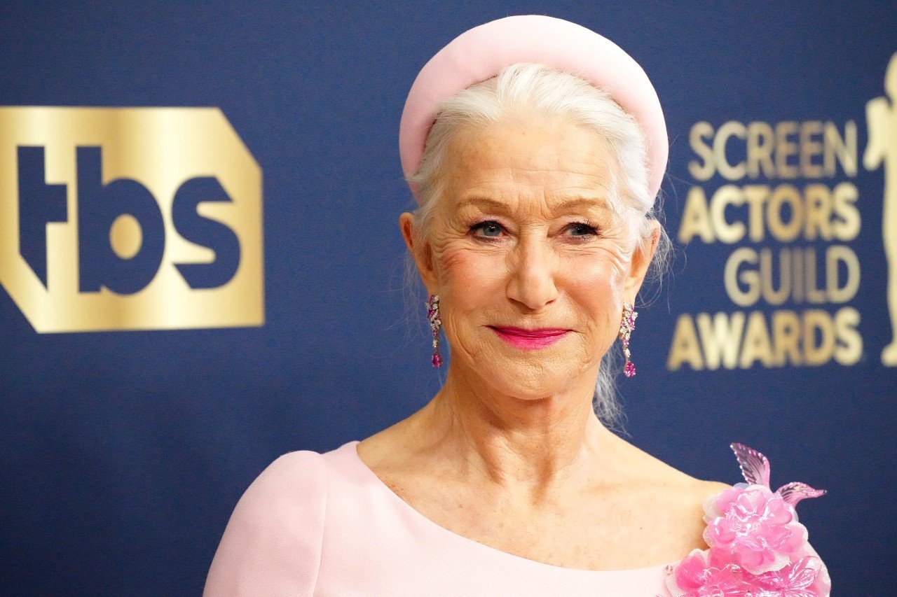 Helen Mirren wears a pink hat and pink dress.