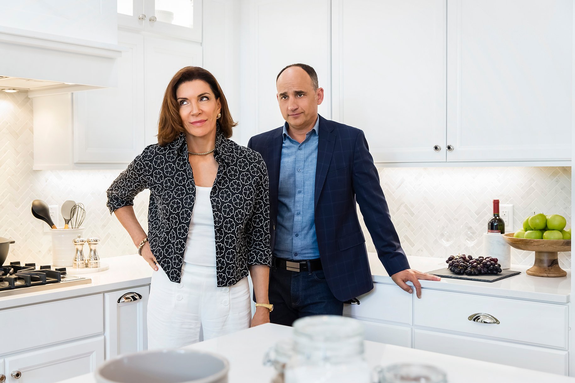 Hilary Farr and David Visentin standing in a white kitchen on 'Love It Or List It'
