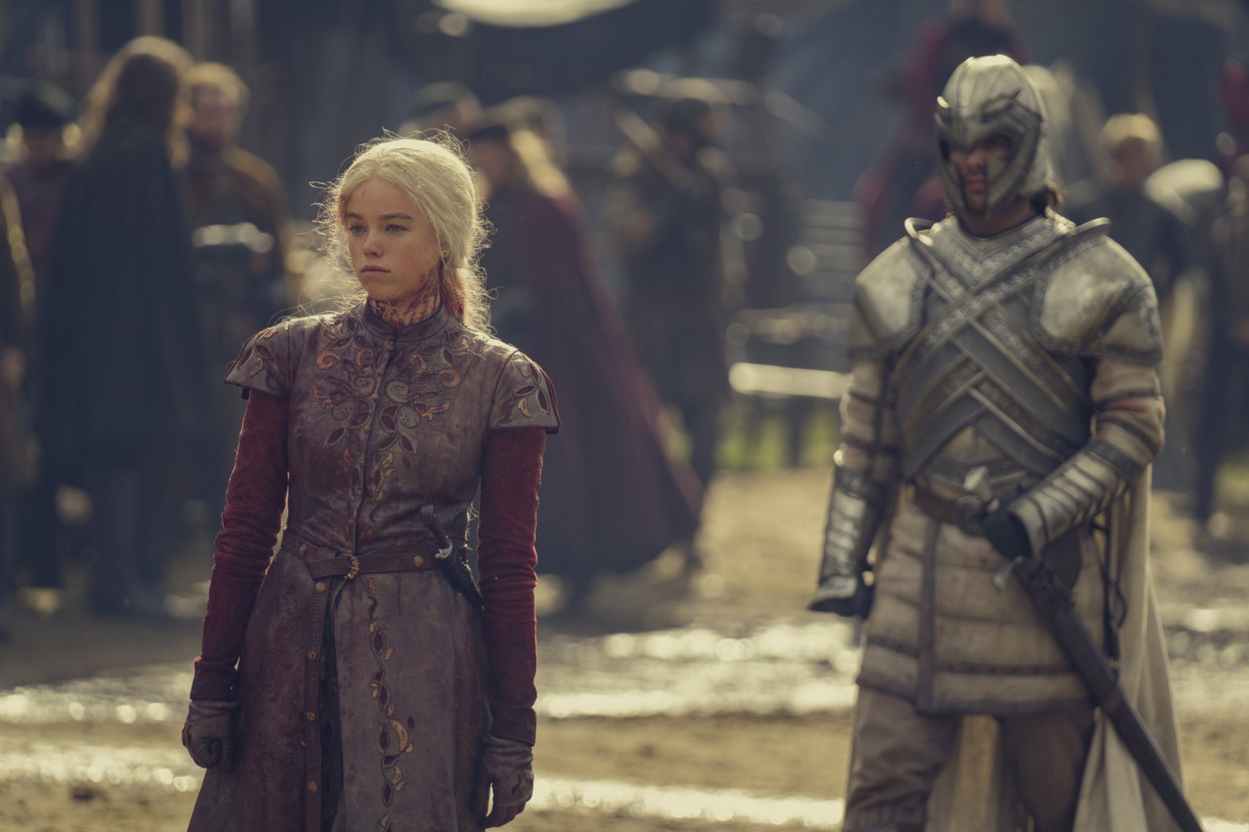 Milly Alcock and Fabien Frankel as Rhaenyra Targaryen and Ser Criston Cole in 'House of the Dragon' Episode 3. Rhaenyra looks disheveled and covered in blood, and Cristen Cole is wearing his armor.