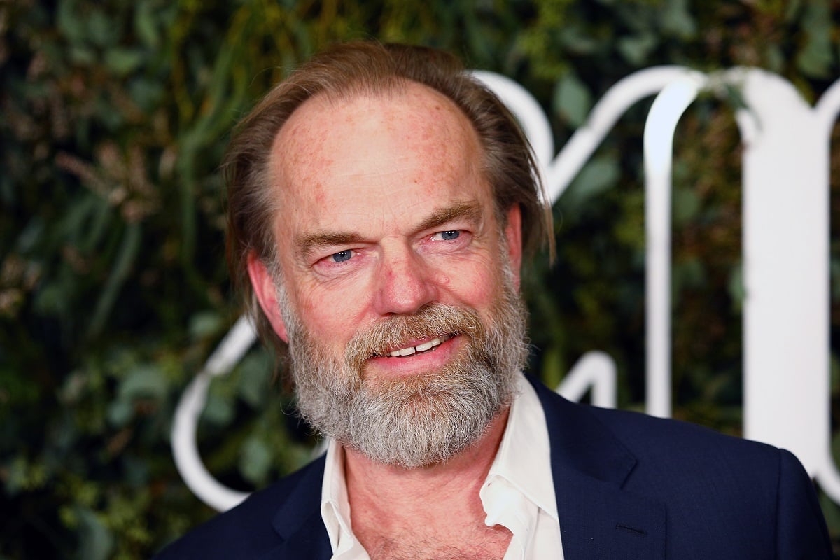 Hugo Weaving smiling while attending a movie premiere,