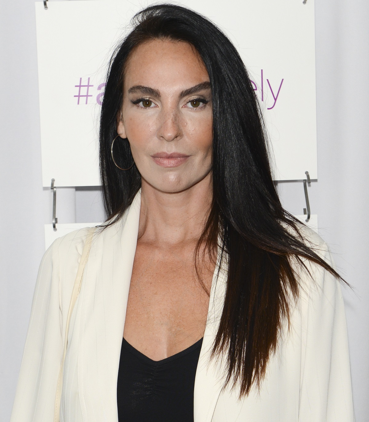 'General Hospital' star Inga Cadranel wearing a black shirt and white blazer during a red carpet appearance.