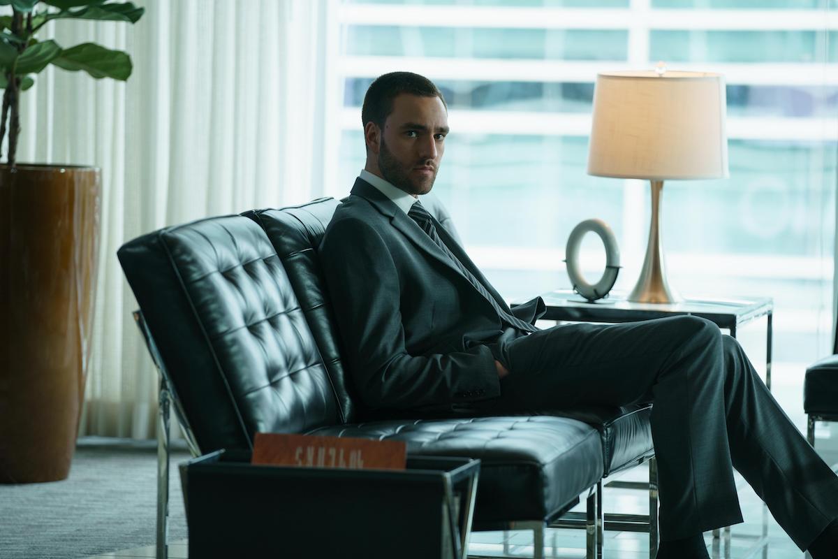 Jackson White sits in a chair wearing a suit in 'Tell Me Lies' Season 1 Episode 4: 'Take Off Your Pants and Jacket'