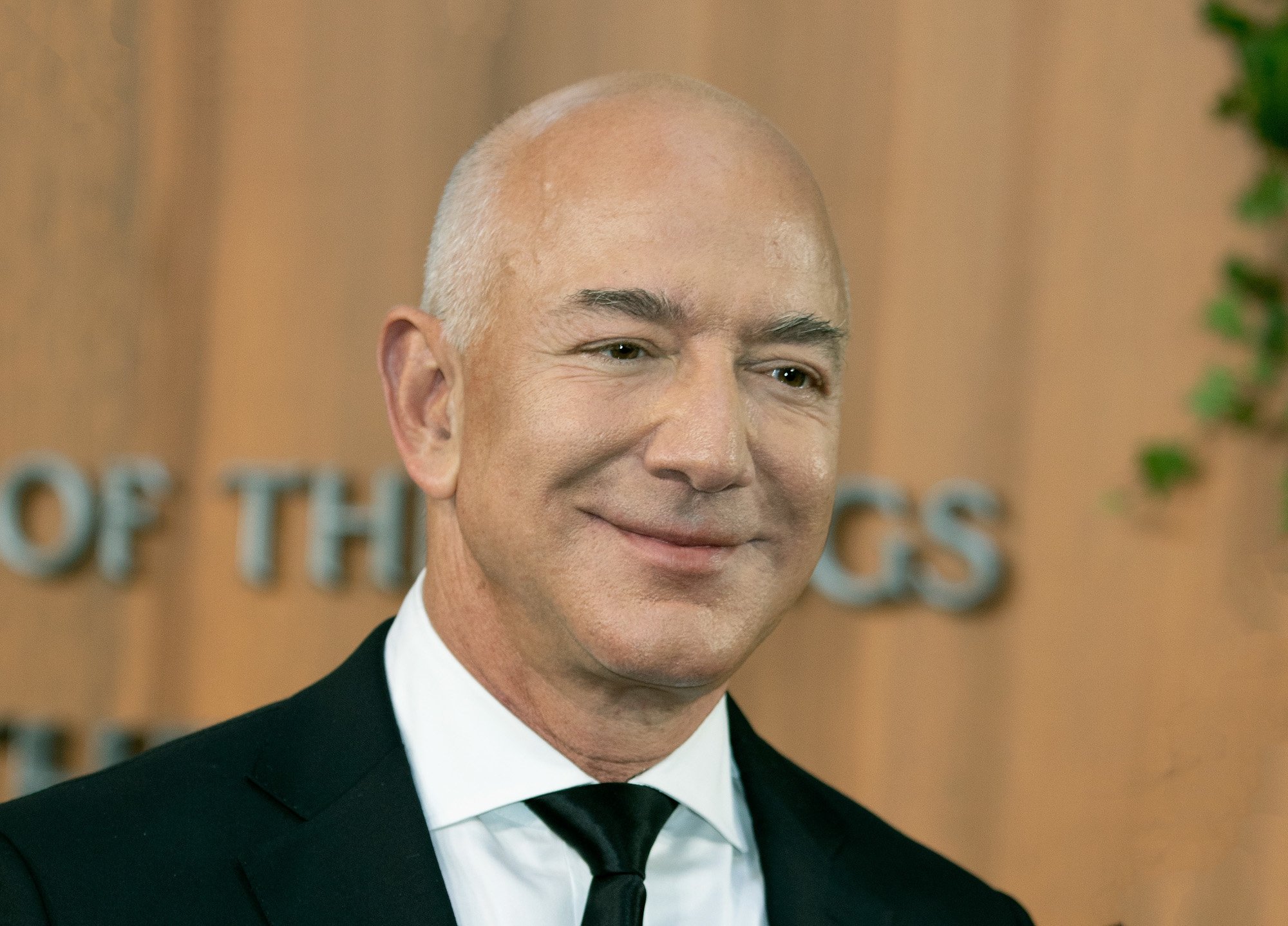 Amazon founder Jeff Bezos at the premiere for 'The Lord of the Rings: The Rings of Power.' He's wearing a white shirt, black suit, and black tie.
