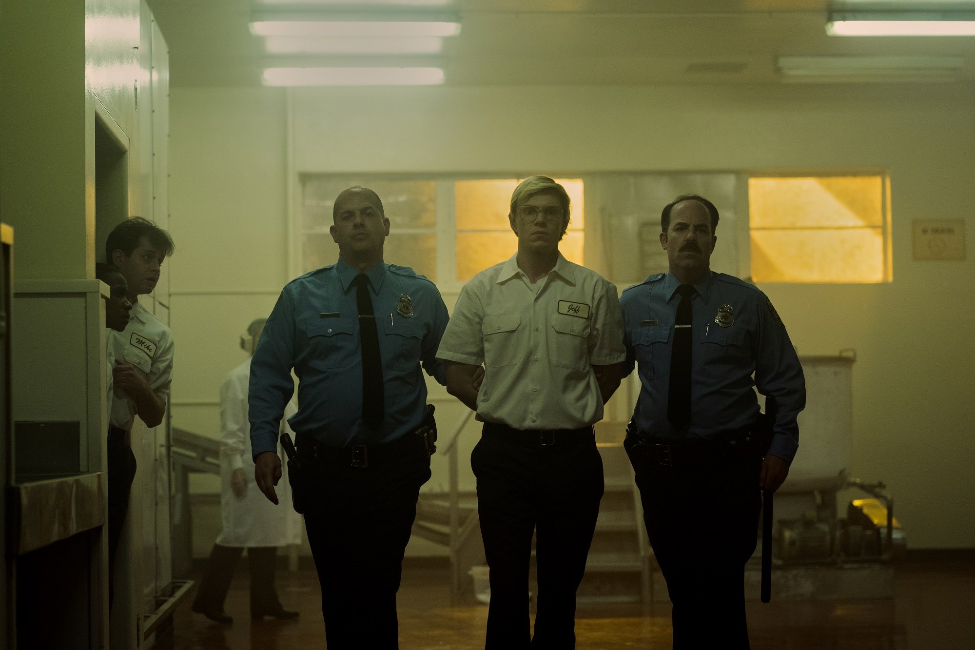 'Dahmer — Monster: The Jeffrey Dahmer Story': Mark Weiler as Officer, Evan Peters as Jeffrey Dahmer walking together