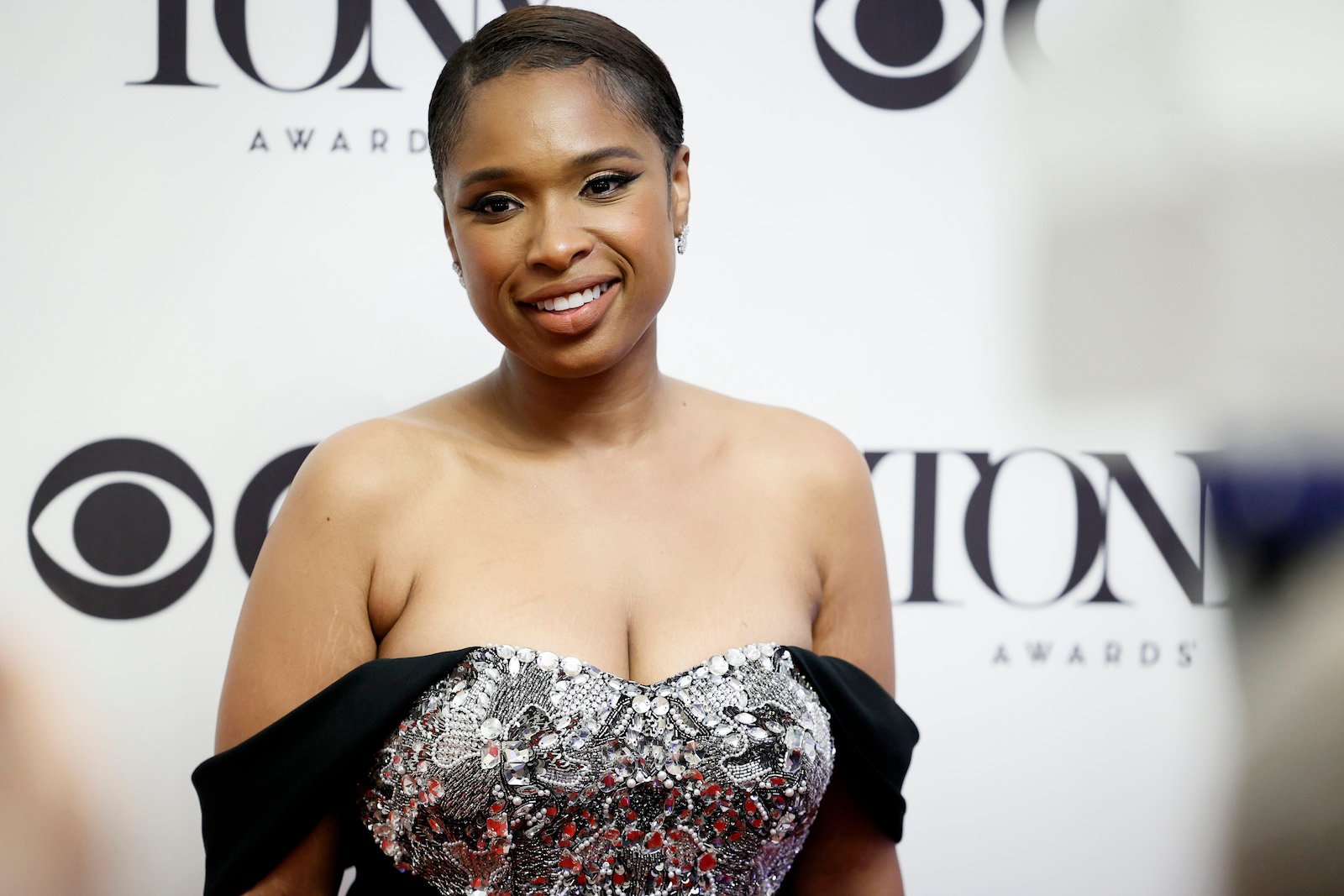 Jennifer Hudson, EGOT winner, wearing a silver and black dress on the red carpet.