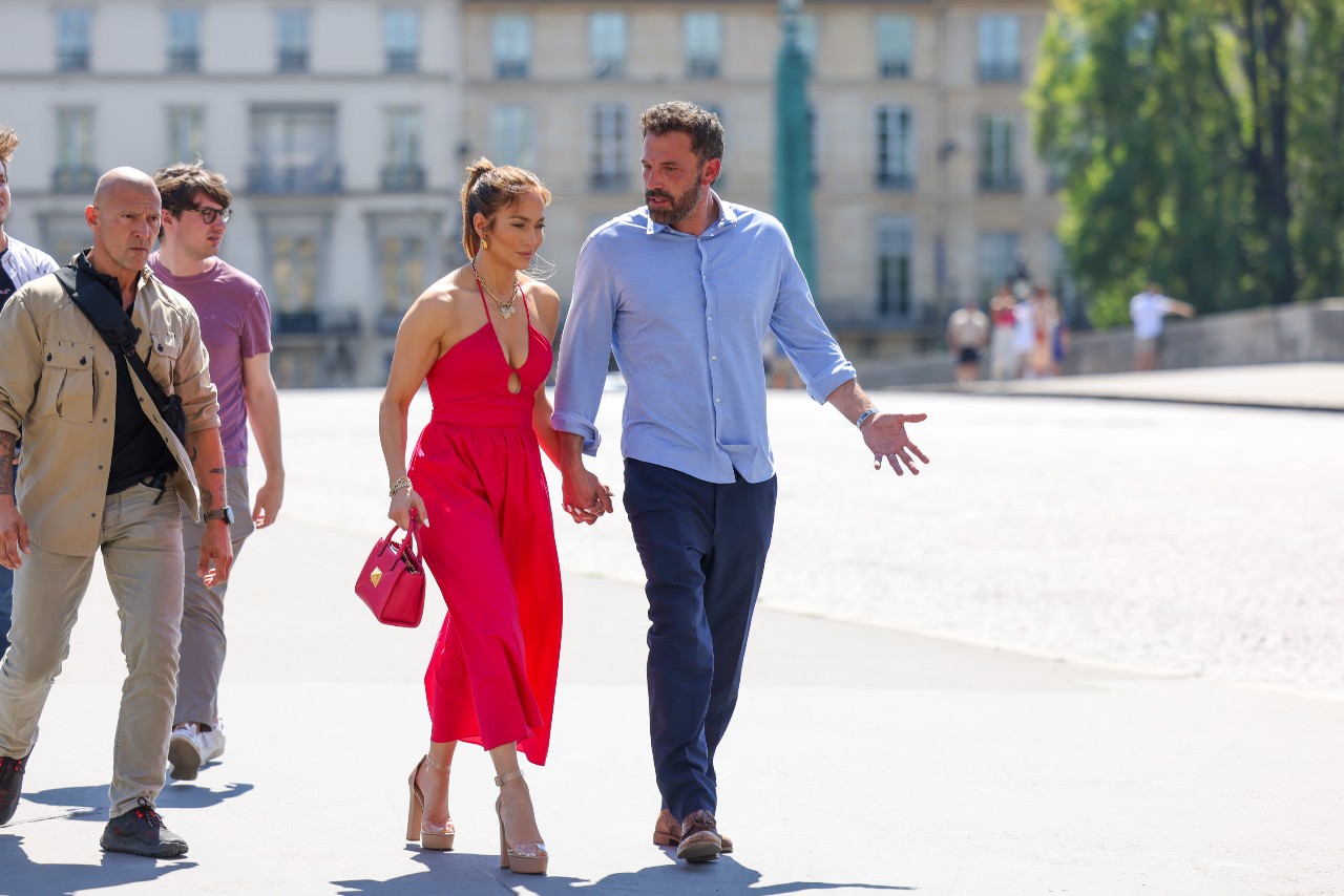 Jennifer Lopez wears a red dress while walking with Ben Affleck.
