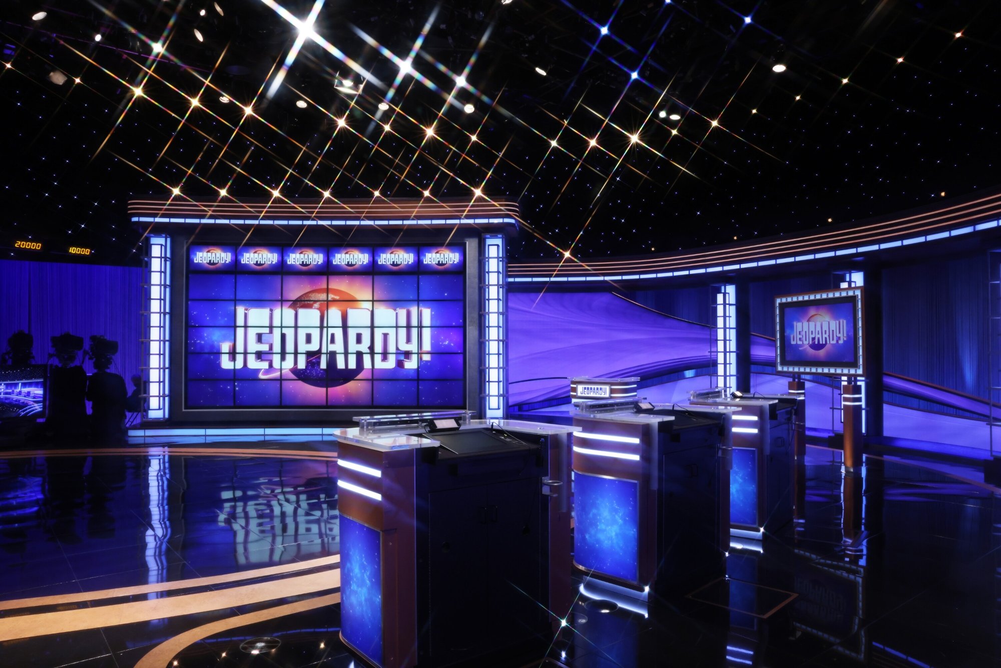 'Jeopardy!' stage that might implement cash bonus. The 'Jeopardy!' game board lit up and the three podiums for the contestants.