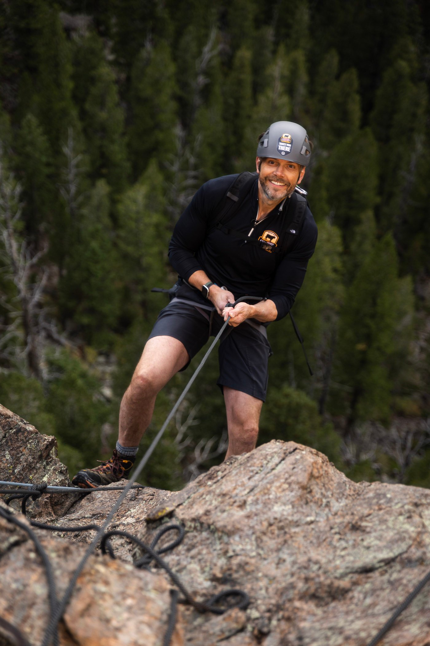 Actor, comedian, and host Joel McHale performing a belayed rappel to the 100-feet high ledge where his epic dinner featuring Certified Angus Beef ® brand awaits