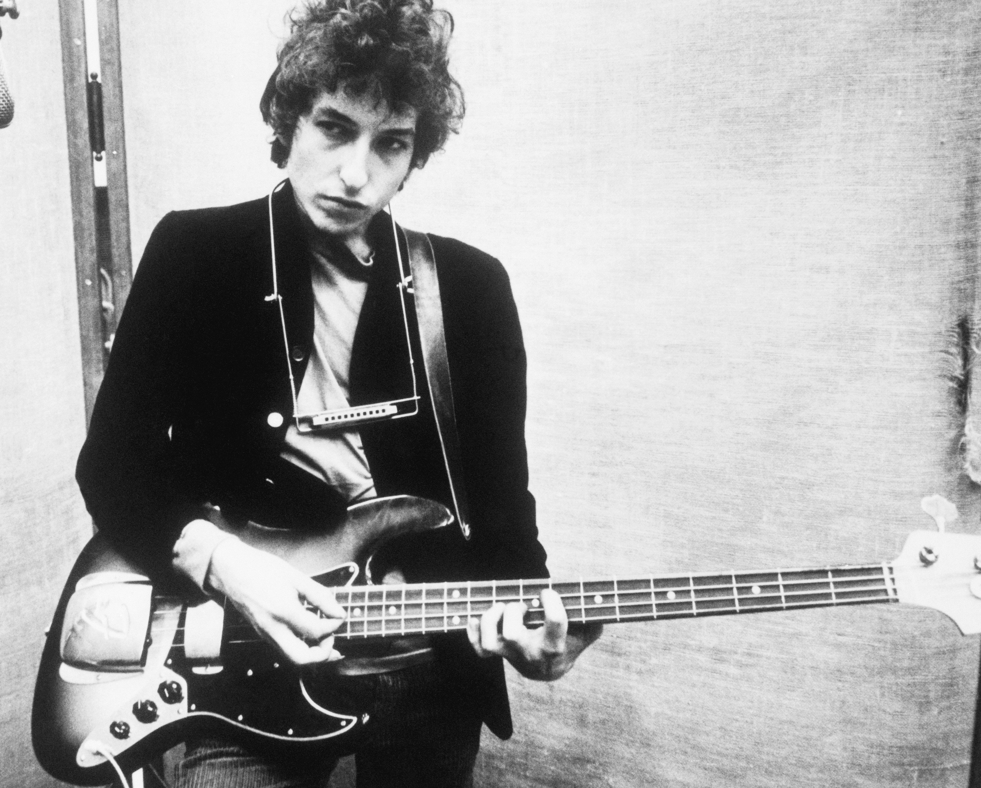 Bob Dylan holding a guitar