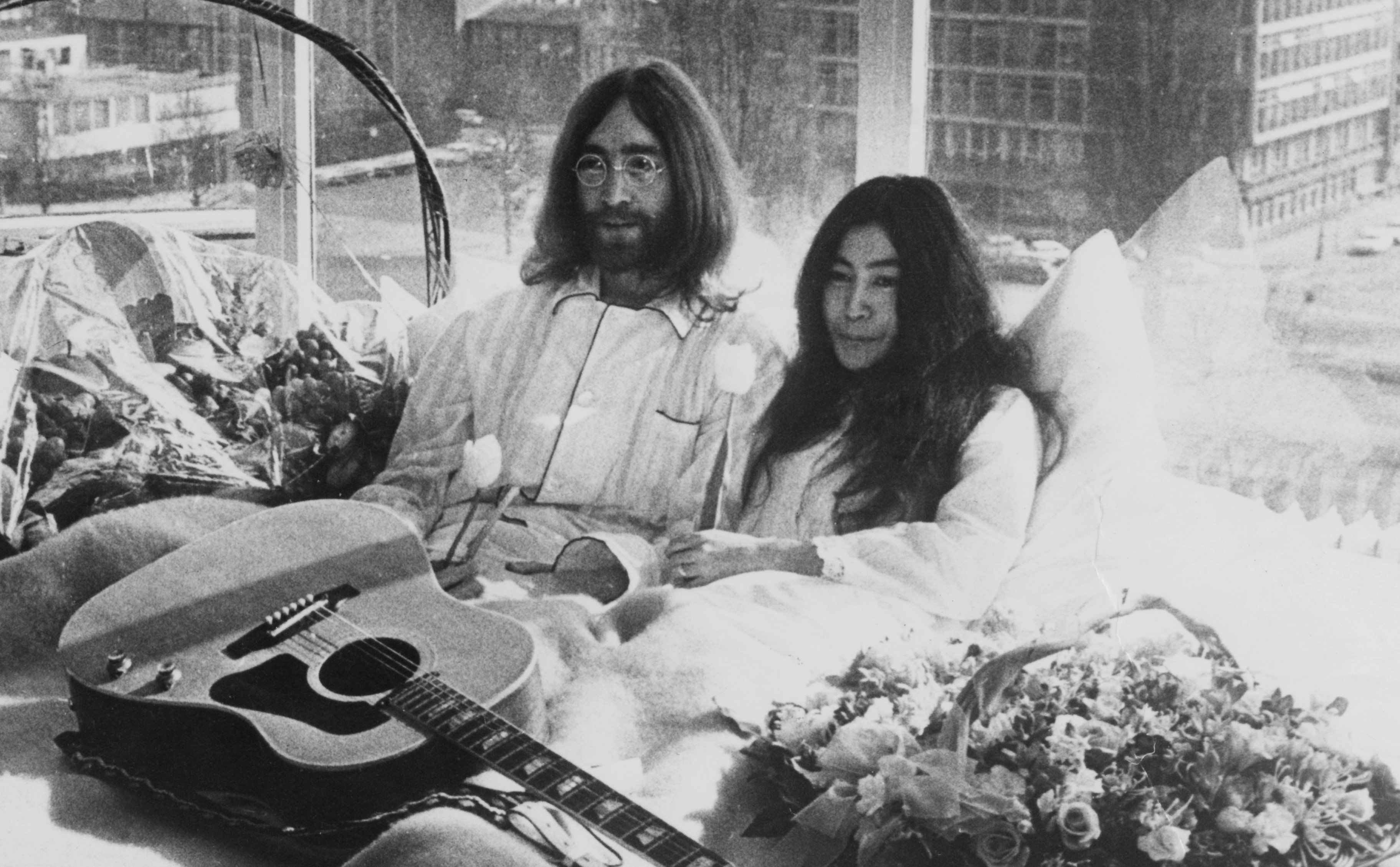 The Beatles' John Lennon with Yoko Ono and a guitar