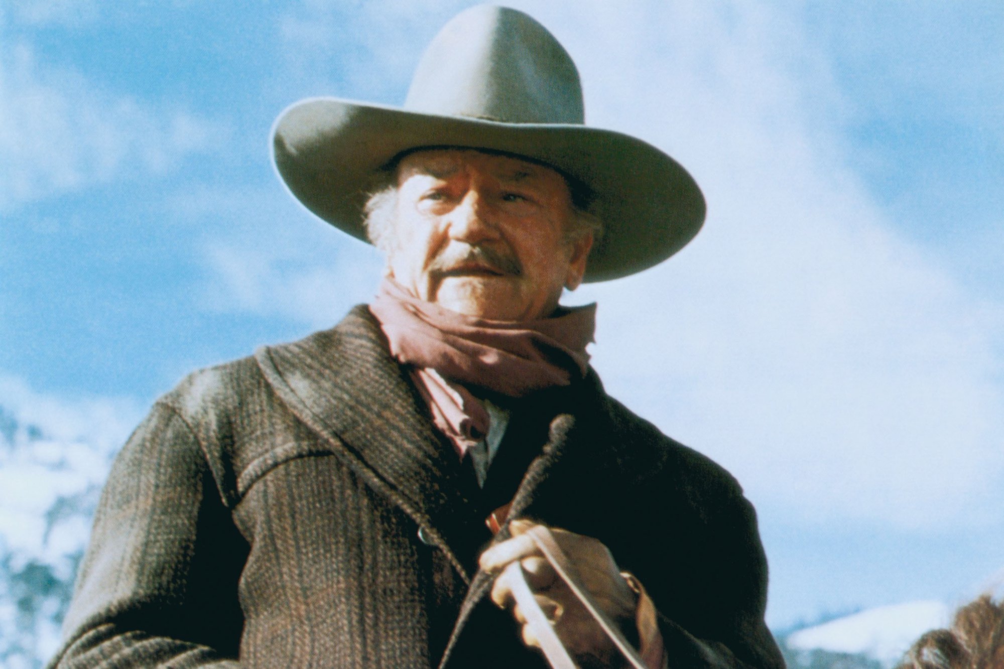 John Wayne in 'The Shootist,' which didn't make money at the box office. He's wearing a Western costume while riding a horse.