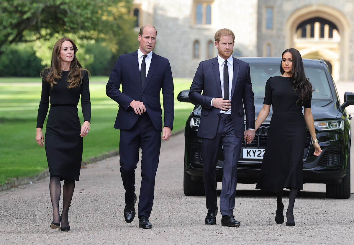 Meghan Markle, who gave Kate Middleton 'side eye' during Windsor Castle walk on Sept. 10, 2022, according to a body language expert, walks with Prince Harry, Prince William, and Kate Middleton