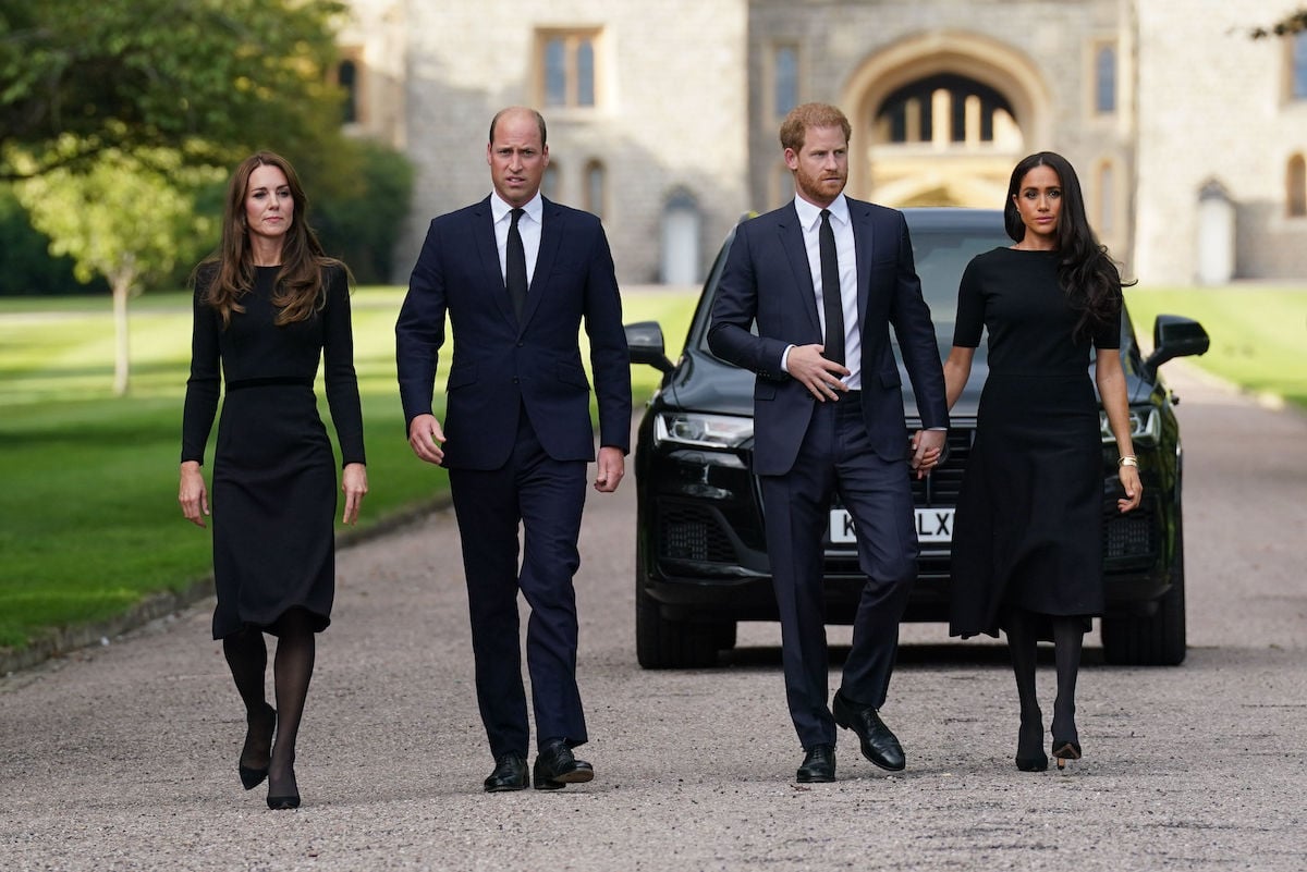 Kate Middleton, who is done being 'overkill' with Prince Harry and Meghan Markle according to a body language expert, walks with Prince William, Prince Harry, and Meghan Markle outside Windsor Castle on Sept. 10, 2022