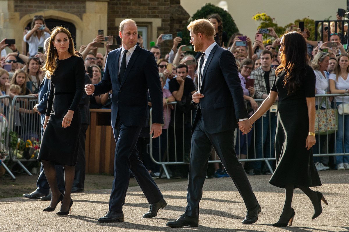 Kate Middleton, who according to a commentator doesn't want to give Meghan Markle the 'time of day' after 2021 Oprah interview in which Meghan Markle said Kate Middleton made her cry, walks with Prince William, Prince Harry, and Meghan Markle outside Windsor Castle