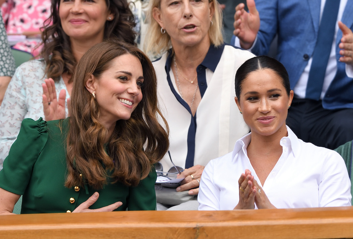 Kate Middleton and Meghan Markle, who both seemed to react to being told they were 'lucky' to marry into the British royal family, sit next to each other at Wimbledon