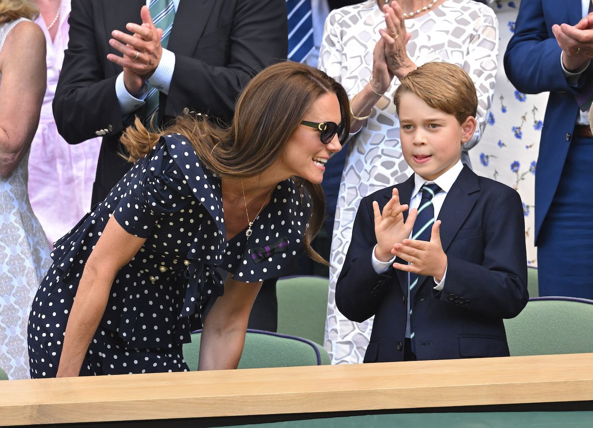 Kate Middleton, who gave a child her 'total attention' by not caring about her coat touching the ground during a Sept. 27 visit to Wales according to body language expert Judi James, crouches down to speak to Prince George