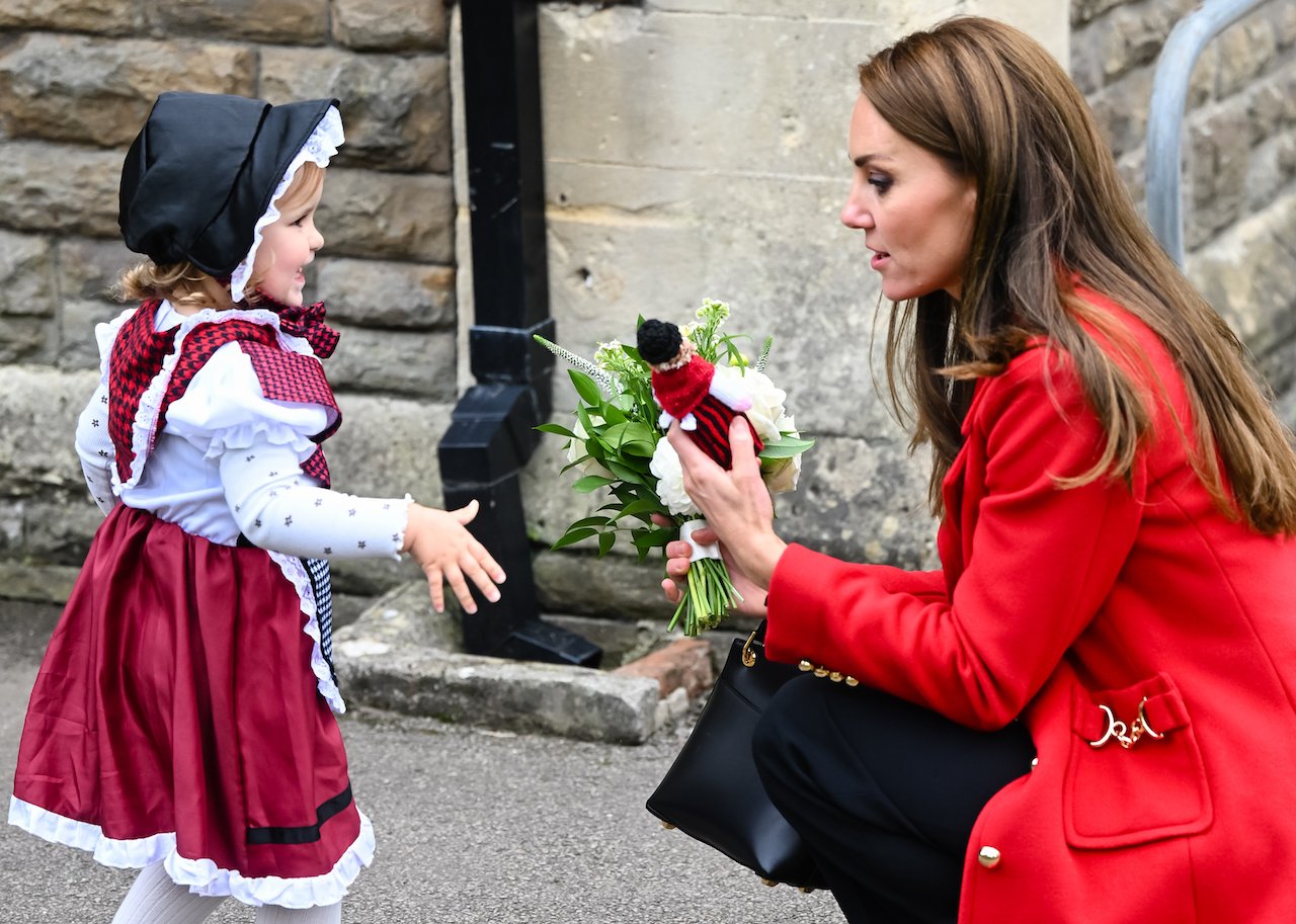 Kate Middleton, Princess of Wales, meets two-year-old Charlotte Bunting in Wales.