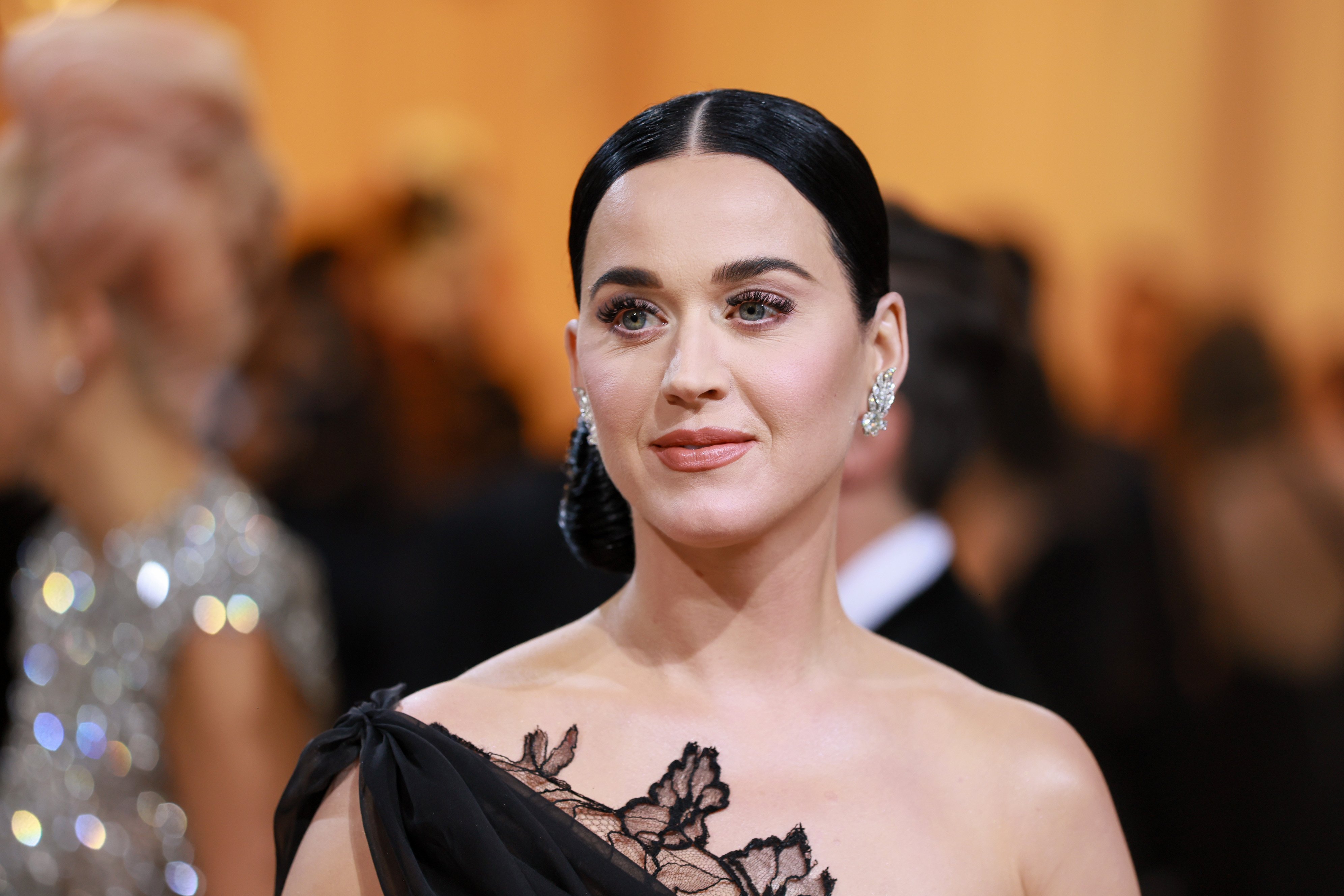 Katy Perry, who is ready to record a new album, wearing black and smiling for a photo at the Met Gala.