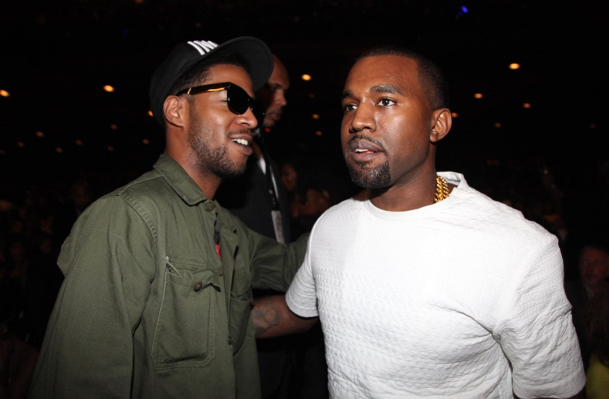 Rappers Kid Cudi and Kanye West greet each other at the 2012 BET Awards
