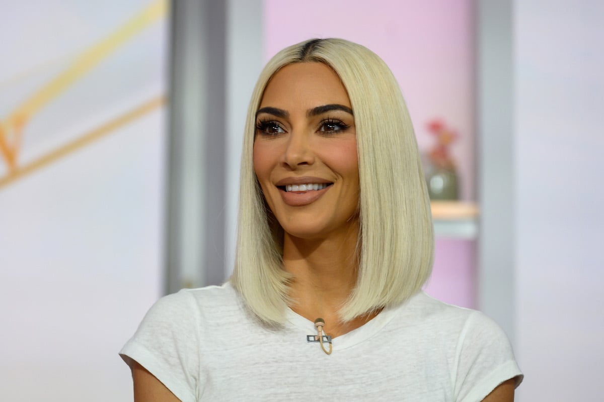 Kim Kardashian, reality star billionaire, smiles during an interview.