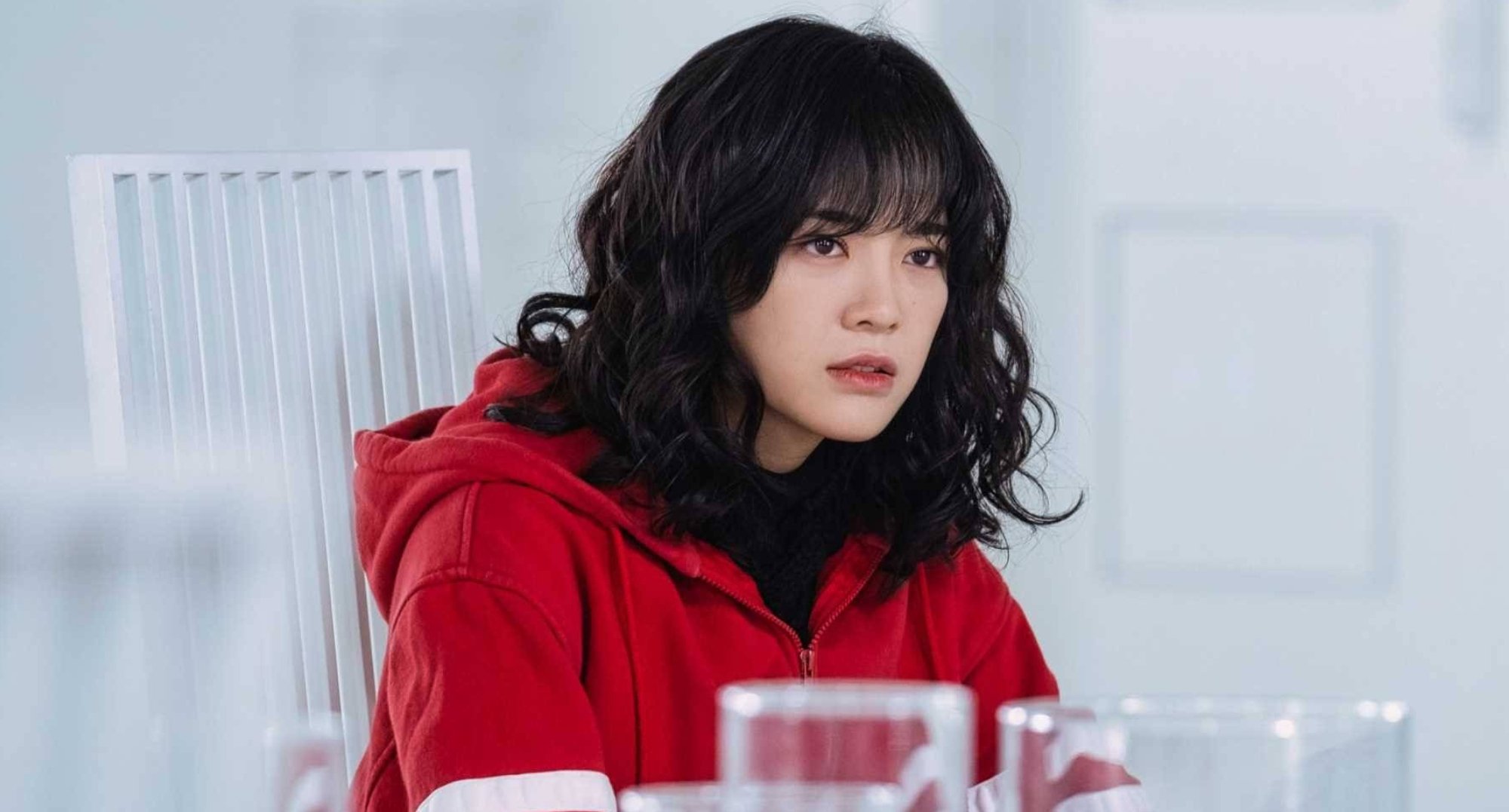 Kim Se-jeong as Do Ha-na in 'The Uncanny Counter' wearing a red tracksuit.