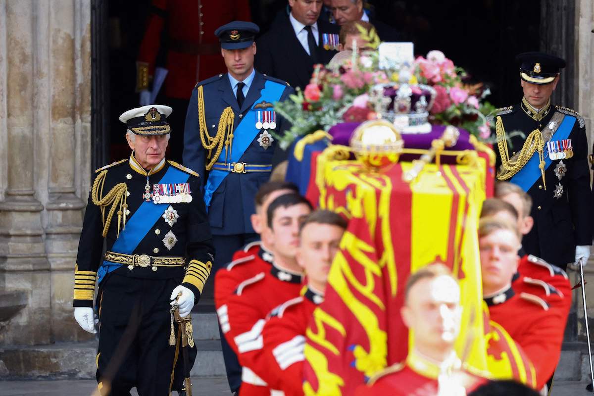 King Charles, who left a handwritten note on top of Queen Elizabeth's coffin, walks next to Queen Elizabeth's coffin with Prince William at Queen Elizabeth's funeral at Westminster Abbey