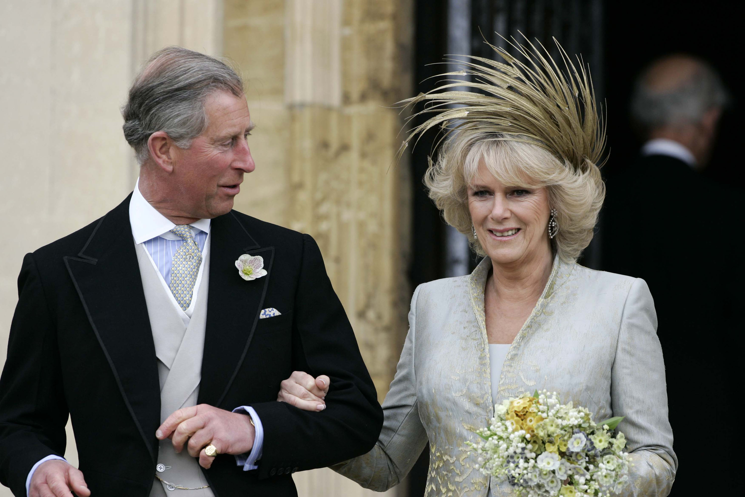 King Charles III and Queen Camilla walk arm-in-arm on their wedding day in 2005.
