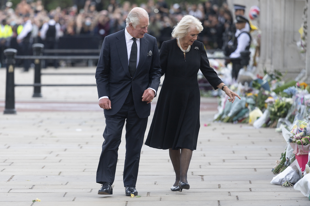 King Charles and Camilla Parker Bowles look at tributes to Queen Elizabeth ahead of Queen Elizabeth's funeral on Sept. 19, 2022, at Westminster Abbey